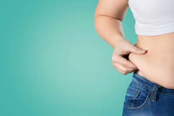 Image of woman pinching her love handles to show weight gain New Scarborough